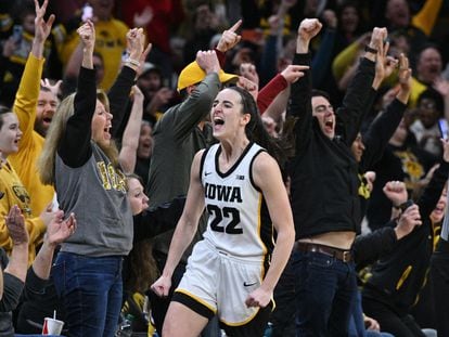 Iowa Hawkeyes guard Caitlin Clark celebrates setting the NCAA women's scoring record in a game against the Michigan Wolverines at Carver-Hawkeye Arena.