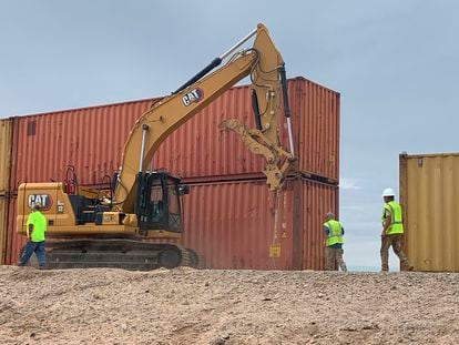 Workers pile up containers near Yuma, Arizona.