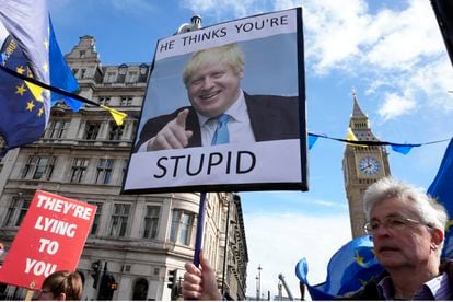 Protestors show placards as they demonstrate near Parliament in London, onMarch 22, 2023.