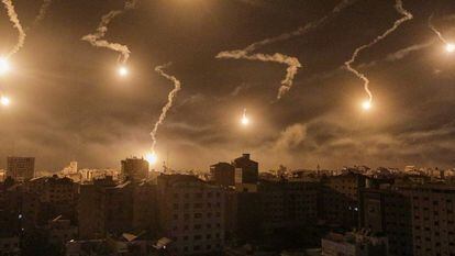 Israeli army flares illuminate the sky over west Gaza in the northern Gaza Strip, on November 6, 2023.