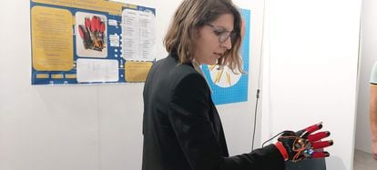Michaela Gallucci demonstrates a glove that replaces a computer keyboard.