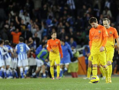 Barcelona&#039;s Lionel Messi (2nd R) and Barcelona&#039;s midfielder Andr&eacute;s Iniesta (R) react after Real Sociedad scored its third goal. 