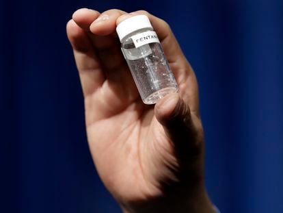 A man holds a vial containing a fatal amount of fentanyl.