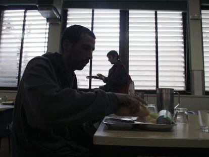 A man prepares to eat his rations in a charity canteen.