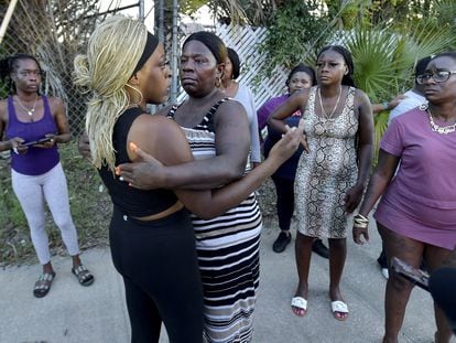 Neighborhood resident Virginia Bradford hugs a woman who came to the police line after going to the hospital to see her child and the child's father who she said were shot at the Dollar General Store in Jacksonville, Florida, U.S. August 26, 2023.
