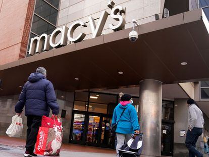 Shoppers walk to the Macy's store in the Downtown Crossing district, Wednesday, Nov. 17, 2021, in Boston.