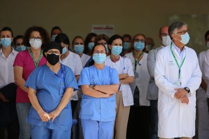 Health workers in Málaga observe a minute of silence for the victims of coronavirus in Spain.