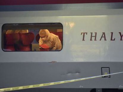 Police inspect the train carriage in which the attack took place.