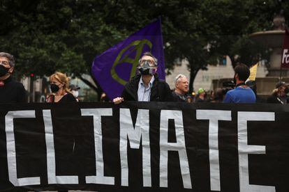 An activist wears a mask to protect himself from smoke during a climate change protest on June 8 in New York. 