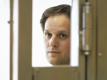 'Wall Street Journal' reporter Evan Gershkovich stands in a glass cage in a courtroom at the Moscow City Court in Moscow, Russia, on June 22, 2023.