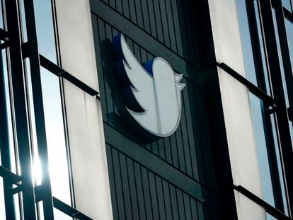 A Twitter logo hangs outside the company's offices in San Francisco, on Dec. 19, 2022