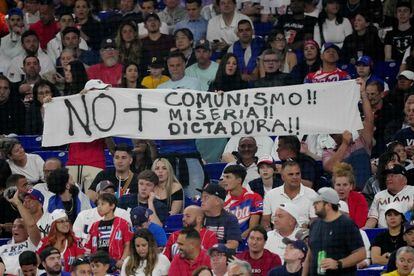 ans hold up signs during the World Baseball Classic Semifinals between Team USA and Team Cuba at loanDepot park on March 19, 2023