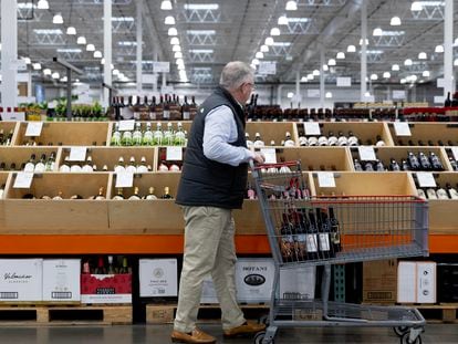 A customer looks at alcohol beverages while shopping at a Costco Wholesale store in Washington, DC, USA, 10 January 2024.