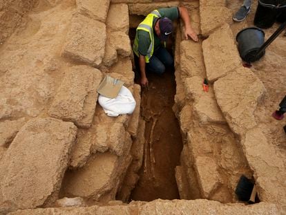 A Palestinian archaeologist removes the sand from a skeleton in a grave at the Roman cemetery in Jebaliya northern Gaza Strip, Saturday, Sept. 23, 2023.