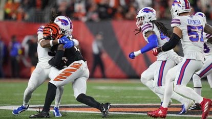 The moment of impact between Bills safety Damar Hamlin (left) and Tee Higgins of the Bengals.