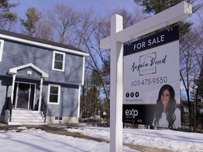 A "For Sale" sign is posted outside a single family home in Derry, New Hampshire.