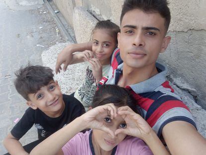 Abdallah Aljazzar, a 24-year-old Gazan, with his younger brothers.