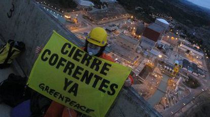 An activist unfurls a banner on a cooling tower at the Cofrentes plant.
