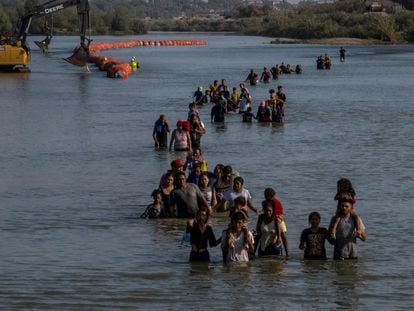Migrants cross the Rio Grande River to enter Eagle Pass, Texas, on July 27, 2023.