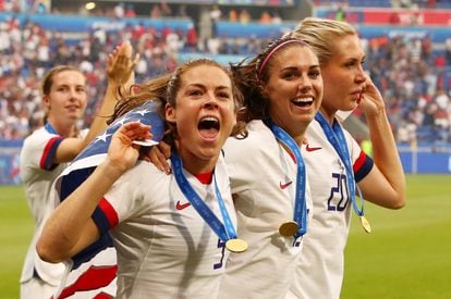 Lindsey Horan, Alex Morgan and Allie Long of the USA celebrate winning the Women's World Cup in 2019. 