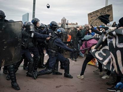 Protesters clash with police officers during a demonstration in Lyon, central France, on March 23, 2023.