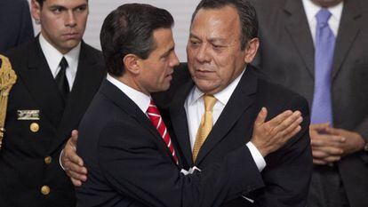 Peña Nieto hugs opposition leader Jesús Zambrano after signing the reform in 2013.