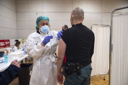 A health worker administering the AstraZeneca vaccine to a Civil Guard officer in a sports facility in Murcia.