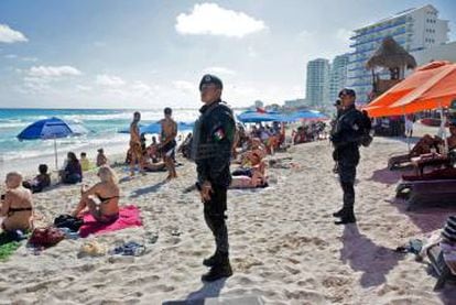 Mexican soldiers patrol the beach at Cancún.