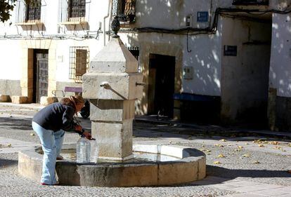 A resident of Chillaron del Rey, Guadalajara, fills bottles of water at the town fountain that is supplied by a local well on November 14, 2017.