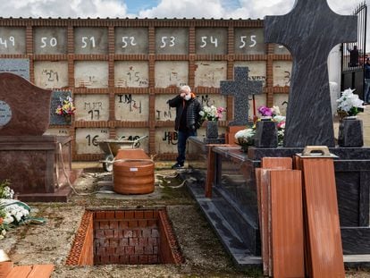 A man attends his mother’s burial, during the coronavirus outbreak in Spain.