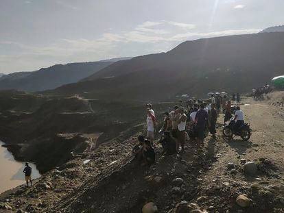 Miners, rescuers and local residents look at the jade mine site where a landslide accident took place in Hpakant township, Kachin state, Myanmar Sunday, Aug. 13, 2023