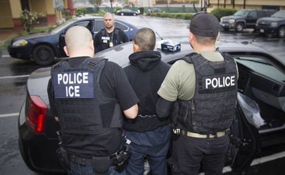 Immigration officers detain a suspected undocumented migrant on February 7 in Los Angeles.