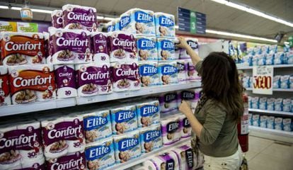 A woman purchases toilet paper at a supermarket in Santiago.