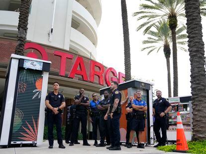 FILE - Police officers stand outside a Target store as a group of people protest across the street, Thursday, June 1, 2023, in Miami. Longtime Pride sponsors like Bud Light and Target have come under attack by conservatives for their LGBTQ-friendly marketing. (AP Photo/Lynne Sladky, File)