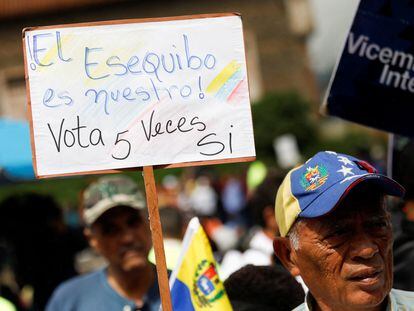 A venezuelan holds a sign that reads: 'The Essequibo is ours' in support of a referendum over Venezuela's rights to the oil-rich region in Guyana, in Caracas, Venezuela November 15, 2023.