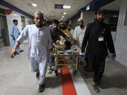 People transport a man, who was injured after a blast in Bajaur district of Khyber Pakhtunkhwa, at the Lady Reading Hospital in Peshawar, Pakistan, on July 30, 2023.