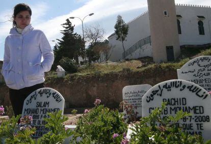 Fatima Mohand Abdelkader, pictured in 2009 in Mellila&#039;s cemetery next to the tombs of her boyfriend, Salam, and his friend Rachid.
