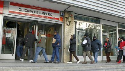 People line up outside an unemployment office in Madrid.