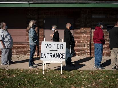 In this Nov. 3, 2020 file photo, voters wait in line outside a polling center on Election Day, in Kenosha, Wis.