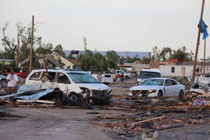 Debris and damaged vehicles cover a street after a tornado hit Perryton, Texas, on June 15, 2023.