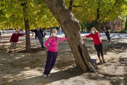 Masked Madrileños take excercise in the Spanish capital's Retiro Park.