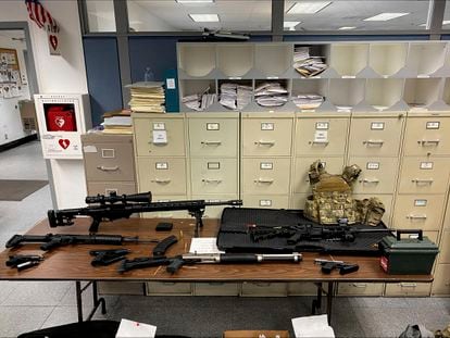 This photo provided by the Los Angeles Police Department shows guns and ammunition that were found in an L.A. apartment.