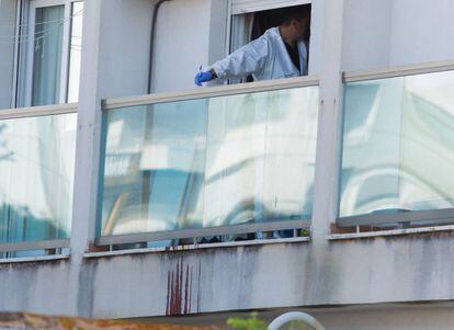 An officer inspects the home where the body of Manuela C. S. was found.