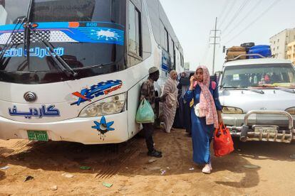 Sudanese civilians wait to board a bus out of Khartoum