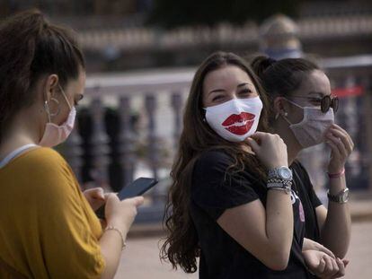 Passers-by wearing masks in Seville on Friday.