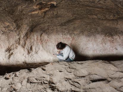 Archaeologist Guadalupe Romero Villanueva documents paintings in the Huenul 1 cave in Argentina's Patagonia region.