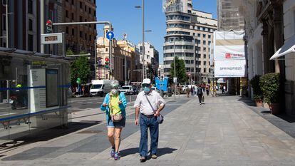 Passers-by with face masks on Madrid's Gran Vía earlier this month.