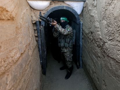 A fighter from the Izz ad-Din al-Qassam Brigades stands in front of a tunnel during an exhibition of weapons, missiles, and heavy equipment for the military wing of Hamas.