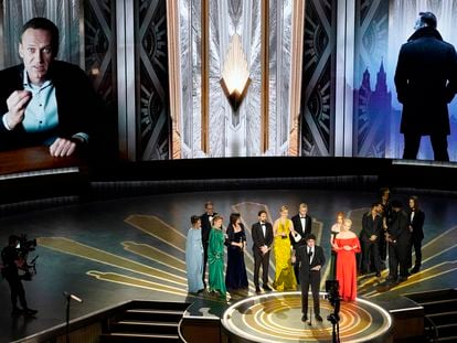 Daniel Roher and the members of the crew from 'Navalny' accept the award for best documentary feature film at the Oscars on March 12, 2023, at the Dolby Theatre in Los Angeles.