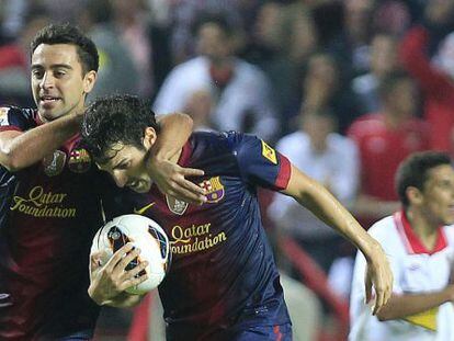 Cesc F&agrave;bregas (r) is congratulated by team captain Xavi after pulling one back for Bar&ccedil;a at Sevilla. 